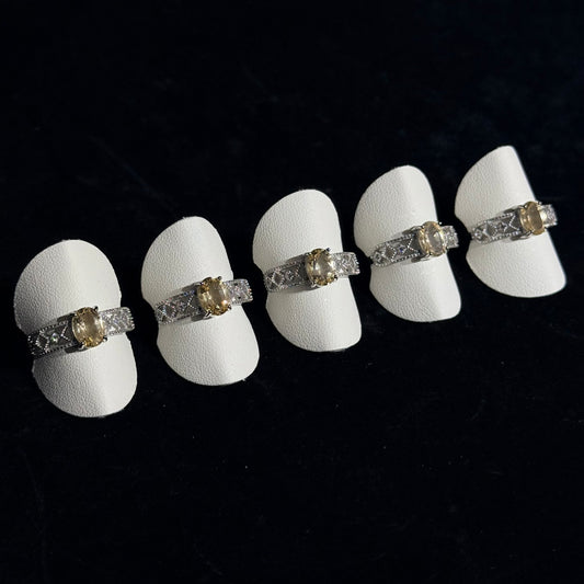 Yellow crystal openwork ring with titanium steel setting